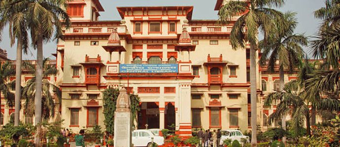 Varanasi, India - January 3, 2013: Students relaxing near the building of Bannares Hindu University with green area on January 3, 2013. The University is one of largest universities in Asia with 20,000 students
